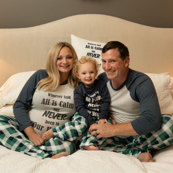 All is Calm family sitting on bed
