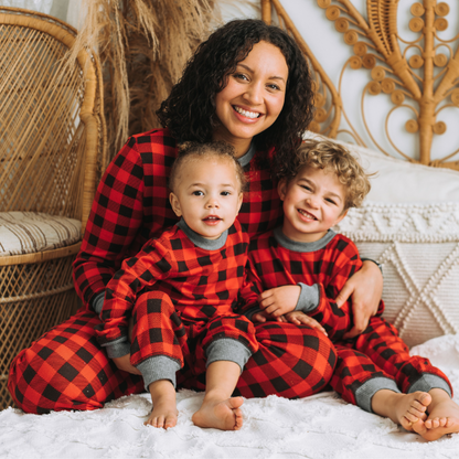 Mother and children wearing red black buffalo pajamas