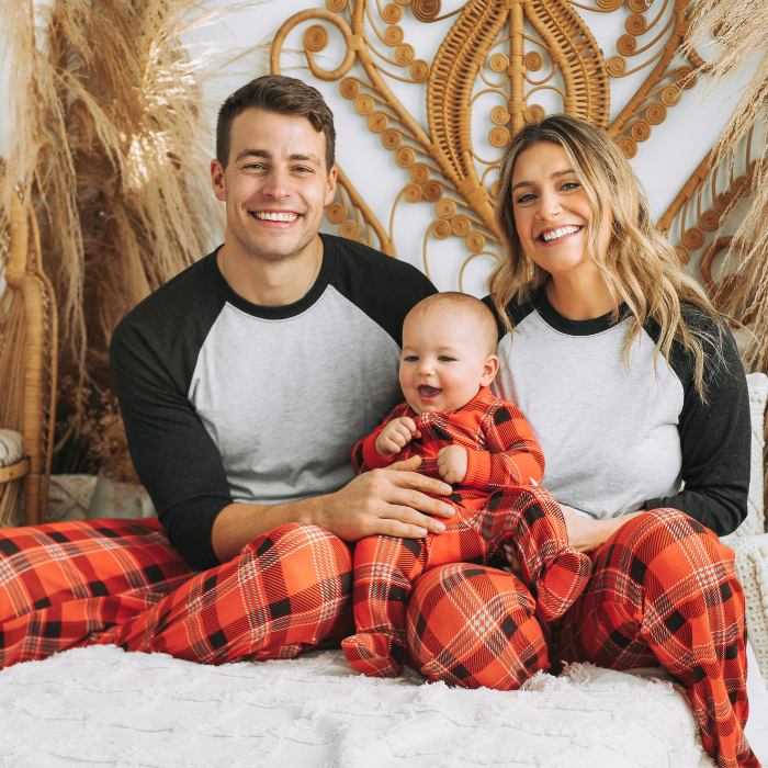family wearing red plaid pants and solid white black raglan shirts