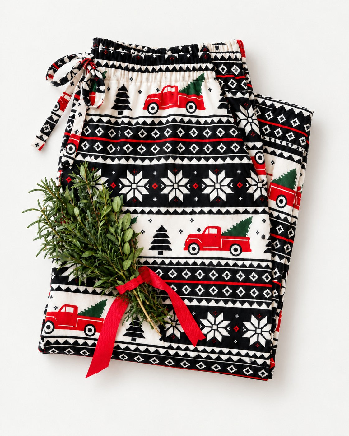 Folded Home for the Holidays fair isle pajamas with a red ribbon