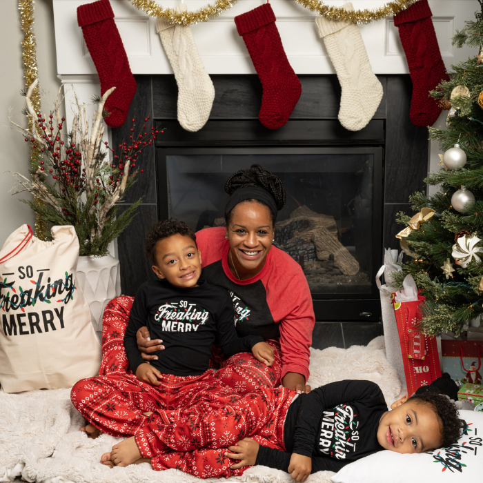 Mother and sons wearing so freaking merry tops and red fair isle pants with santa sack