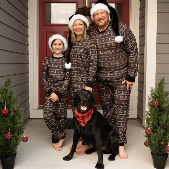 family wearing black fair isle on front porch with dog in bandana