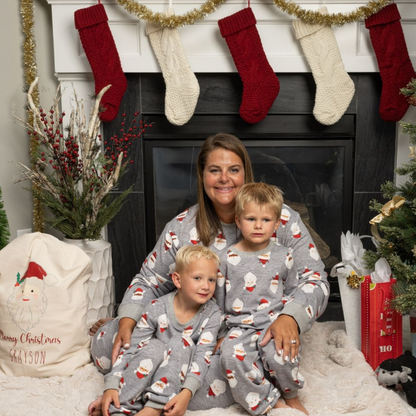 Plus size mom with sons wearing gray santa pajamas