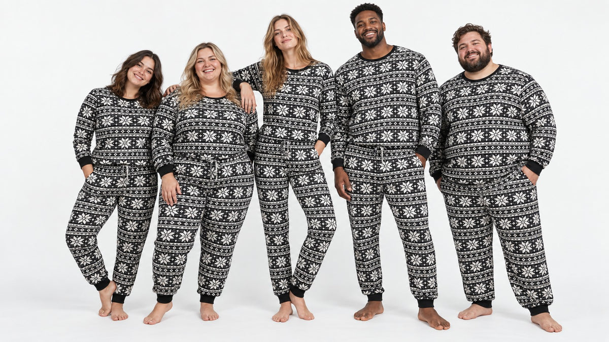 Five adults wearing matching Baby It’s Cold Outside pajamas in different fits