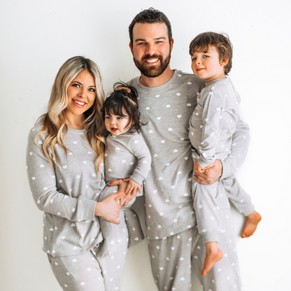 mother, father, son and daughter in gray hearts pajamas