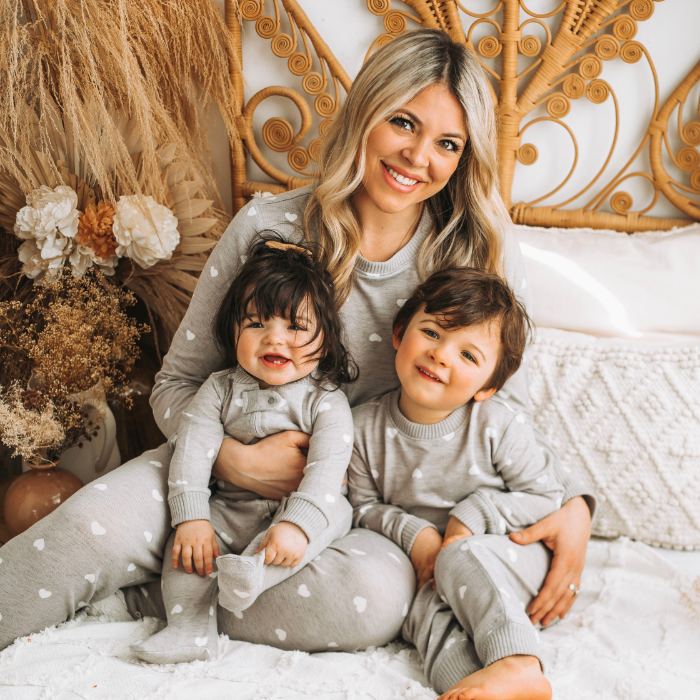 Mother, son and daughter in gray hearts pajamas
