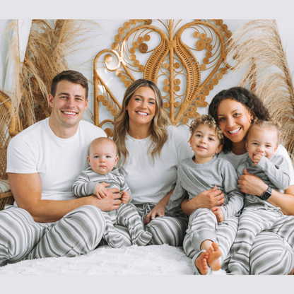 family wearing gray stripe joggers sitting on bed