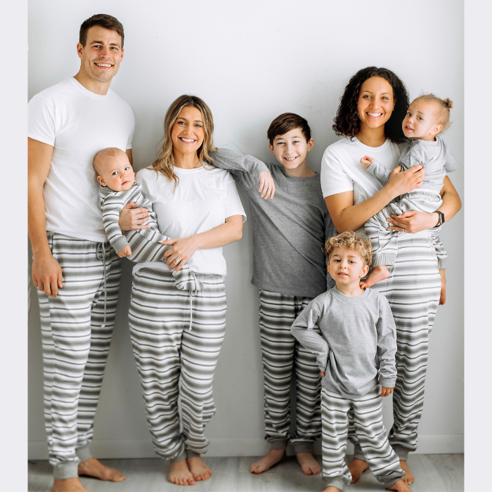 family wearing gray stripe joggers standing