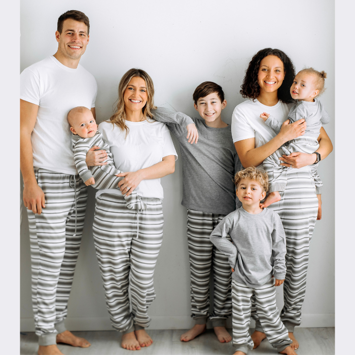 family wearing gray stripe joggers standing 