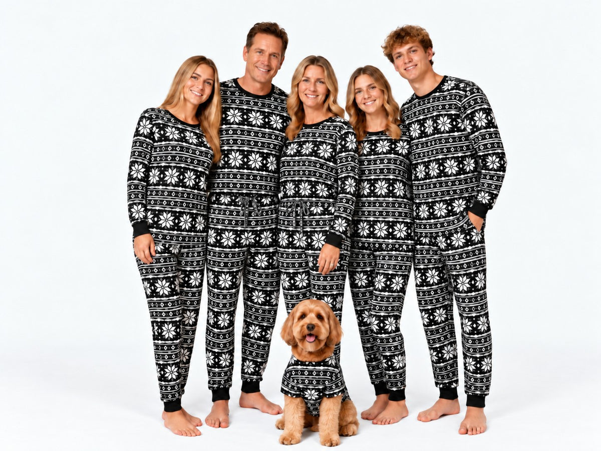 Family and dog in matching Baby It's Cold Outside fair isle pajamas