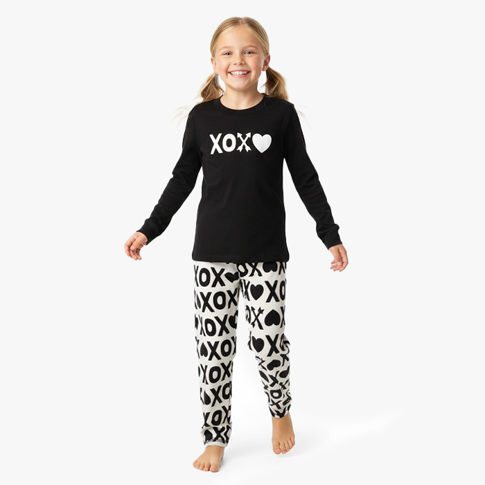 kid wearing black xoxo shirt white black xoxo pant