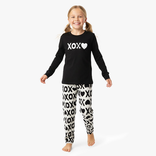 kid wearing black xoxo shirt white black xoxo pant