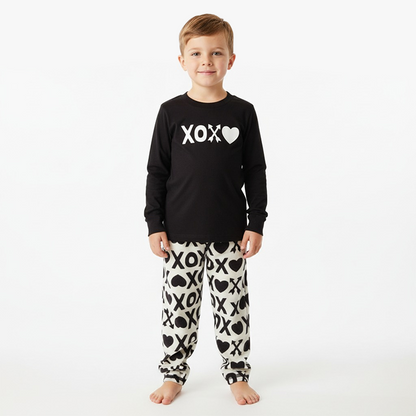 kid wearing black xoxo shirt white black xoxo pant